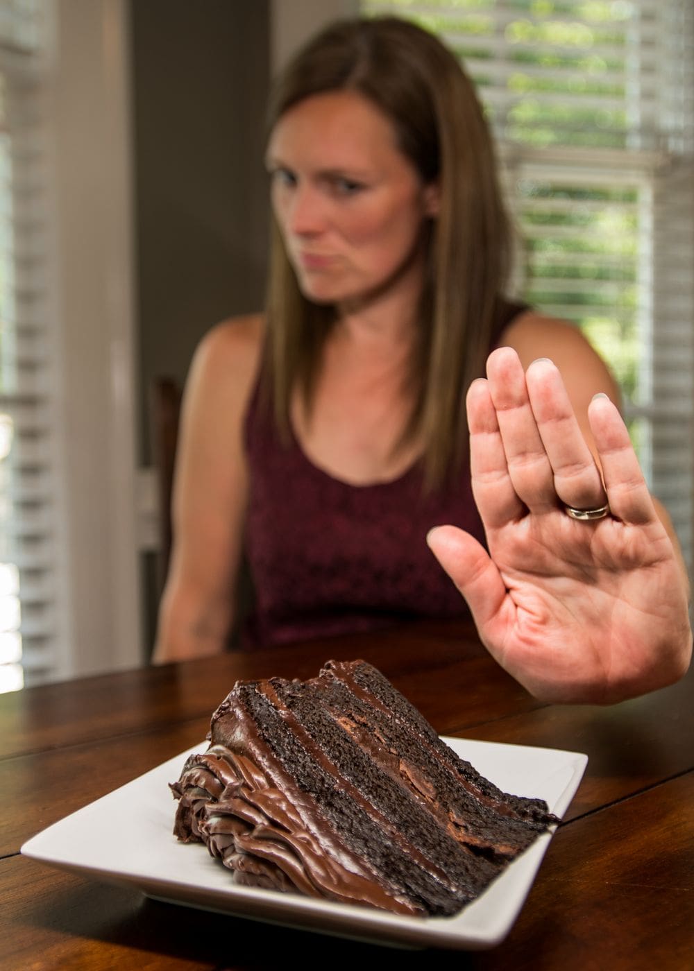 Woman Resisting temtation by not eating Chocolate Cake